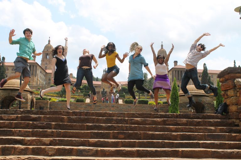 Students jumping in unision on steps