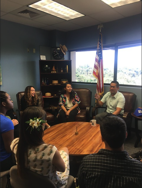 Professor leads group in a discussion around a table